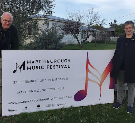 Trustee and Festival Director, Brendan Smyth helps Andrew Morrison put the 2019 sign up on the corner of Kitchener and Princess Streets to welcome visitors to Martinborough.