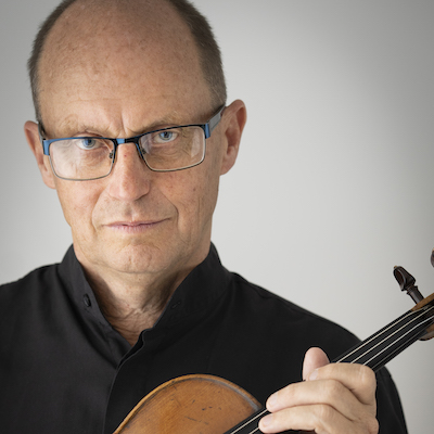 Donald Armstrong looking serious and holding his violin