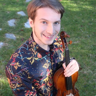 Lucas Baker holding his violin