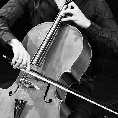 Cropped photo showing a cello being played