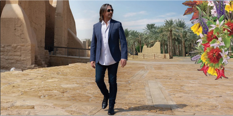 Lee Bradshaw walking through a dusty park in Saudi Arabia